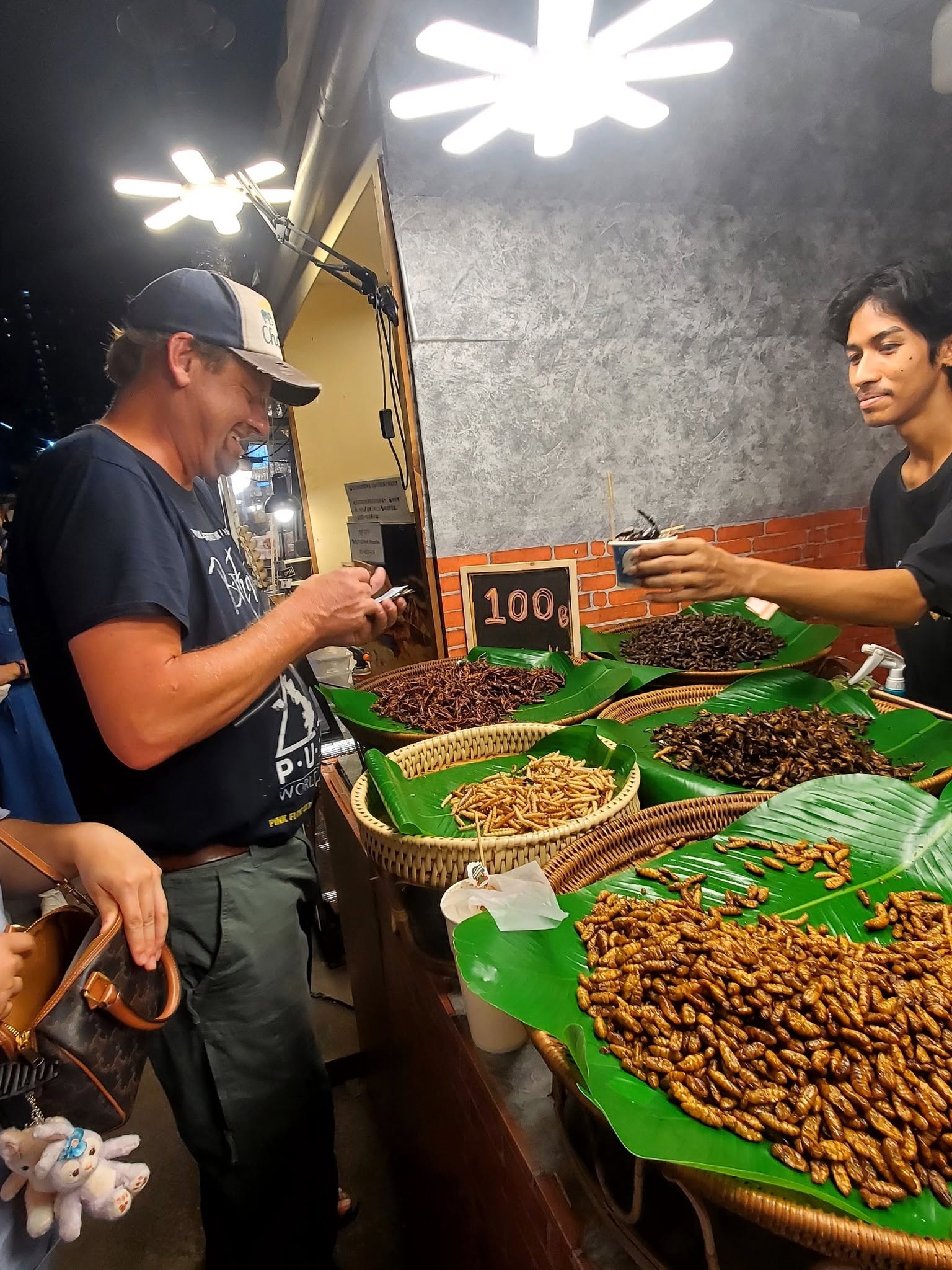 Brice at the insect stall — when in Thailand...