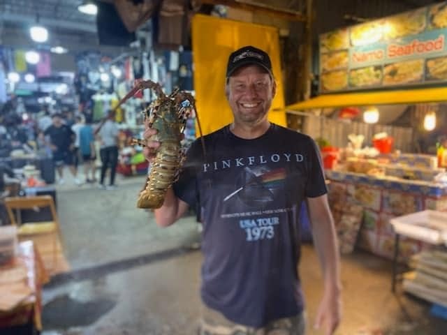 Brice with a live lobster at the seafood market